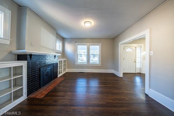 unfurnished living room featuring dark wood-type flooring