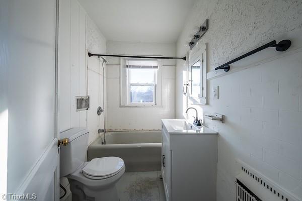 full bathroom with shower / bathing tub combination, vanity, radiator, and toilet