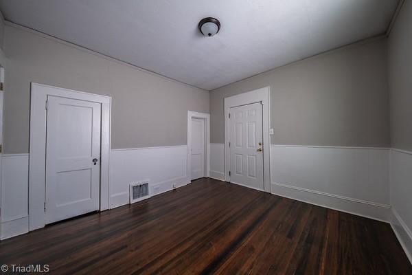 spare room with dark hardwood / wood-style floors