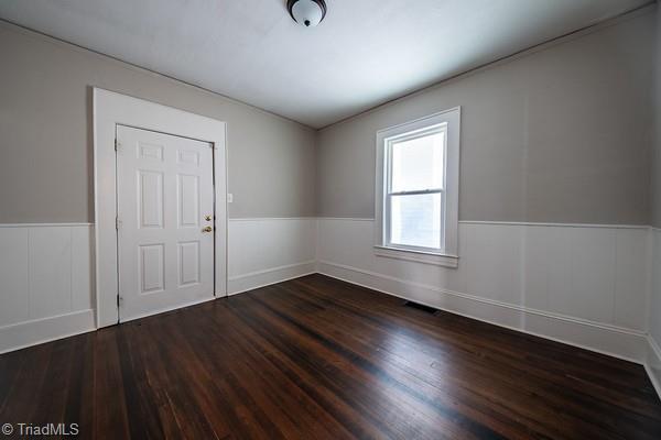 empty room with dark hardwood / wood-style floors