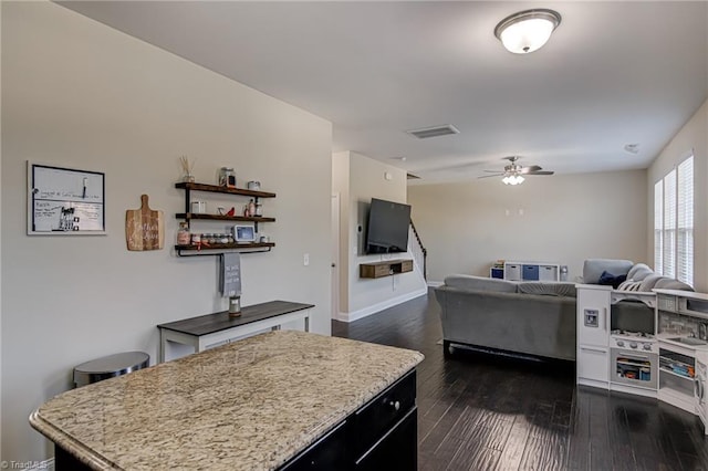 kitchen featuring ceiling fan and dark wood-type flooring