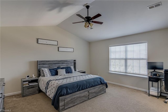 bedroom with ceiling fan, light colored carpet, and vaulted ceiling