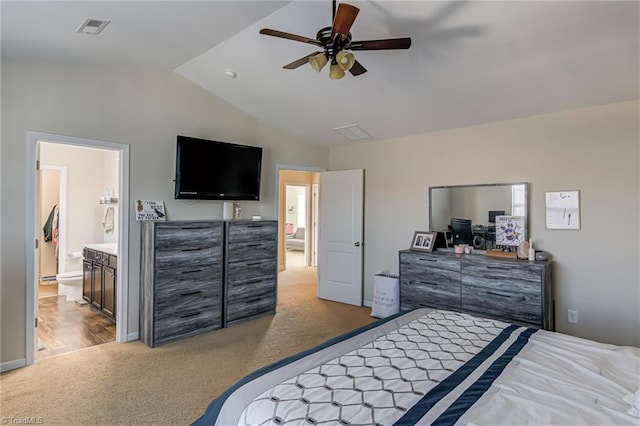 carpeted bedroom featuring vaulted ceiling, connected bathroom, and ceiling fan