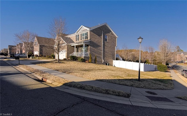 front facade featuring a porch and a front lawn