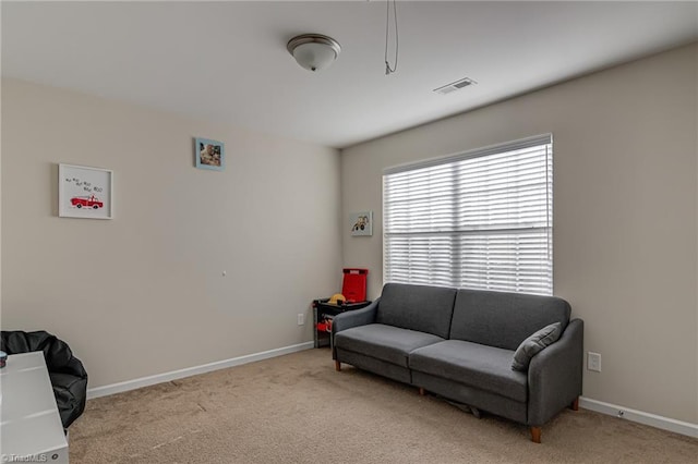 sitting room featuring light carpet