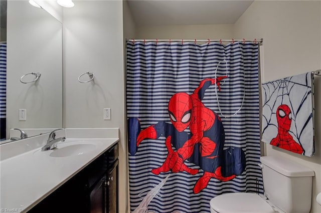 bathroom with toilet and vanity