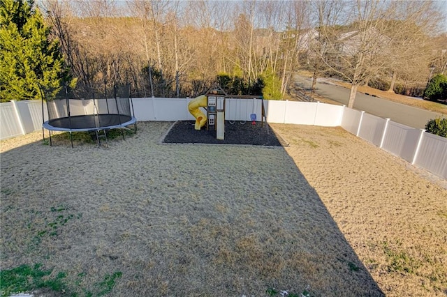 view of yard featuring a playground and a trampoline