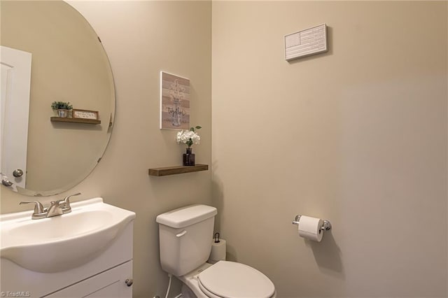 bathroom with toilet and vanity