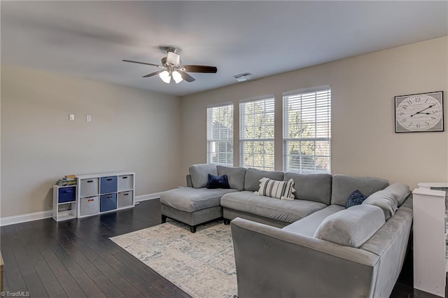 living room featuring dark wood-type flooring and ceiling fan