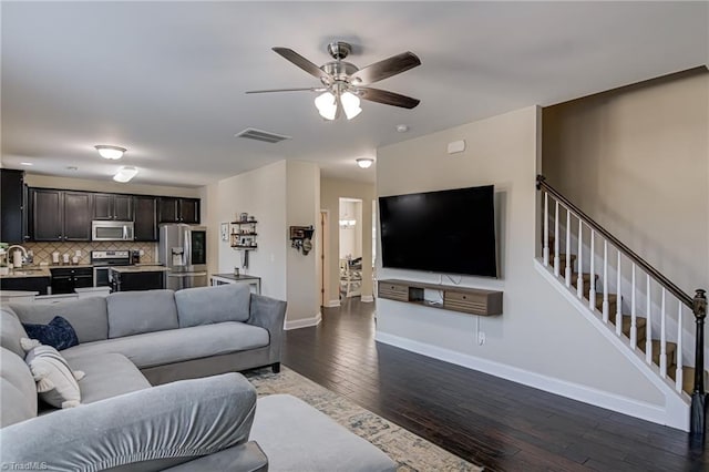 living room with sink, ceiling fan, and dark hardwood / wood-style floors