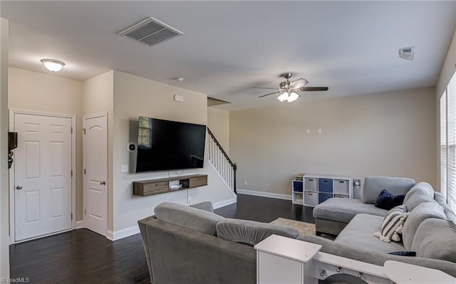 living room featuring ceiling fan, dark hardwood / wood-style flooring, and a healthy amount of sunlight