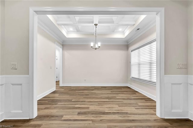 interior space featuring a notable chandelier, hardwood / wood-style floors, coffered ceiling, and beamed ceiling