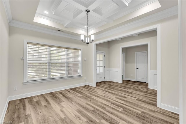 unfurnished dining area with coffered ceiling, a notable chandelier, light wood-type flooring, ornamental molding, and beam ceiling