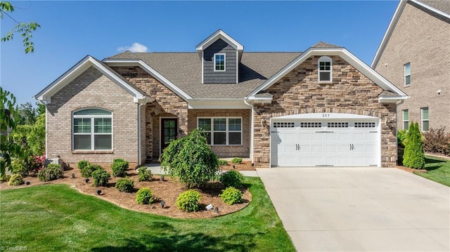 view of front of property featuring a front yard and a garage