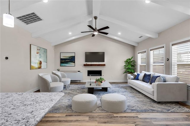 living room featuring hardwood / wood-style flooring, lofted ceiling with beams, and ceiling fan