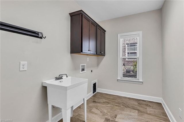 laundry area with washer hookup, cabinets, sink, and electric dryer hookup