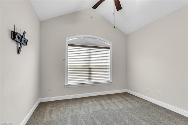 carpeted spare room featuring ceiling fan and lofted ceiling