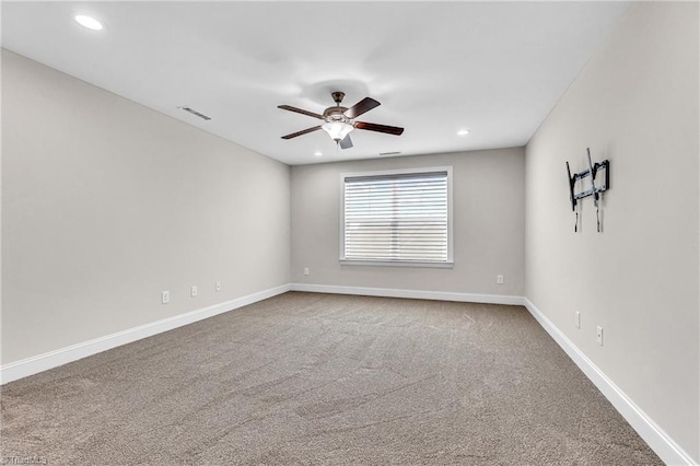 carpeted spare room with ceiling fan