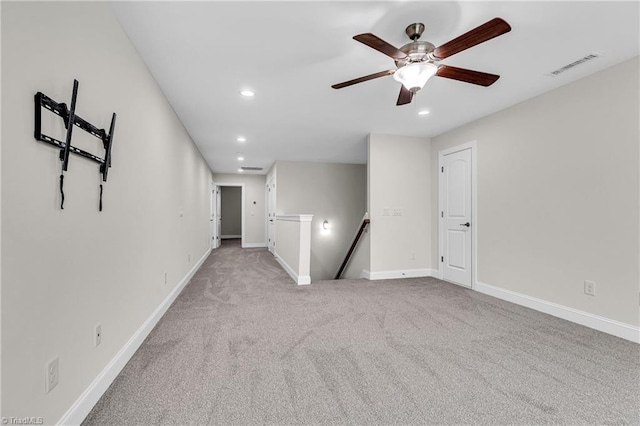 carpeted empty room featuring ceiling fan