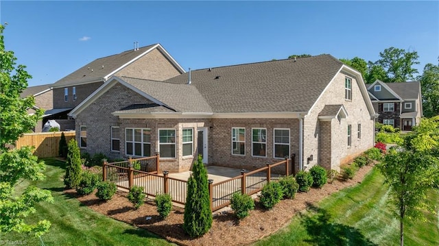 rear view of house with a yard