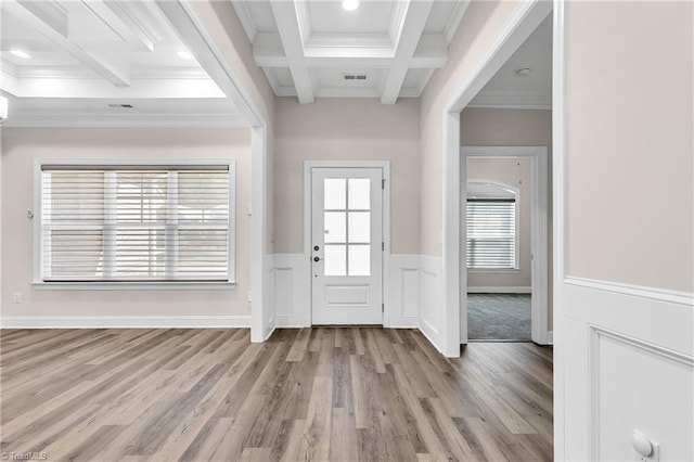 entrance foyer featuring beam ceiling, light hardwood / wood-style floors, coffered ceiling, and ornamental molding