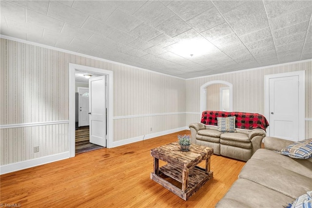 living room with hardwood / wood-style flooring and ornamental molding