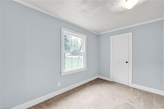 empty room featuring light carpet and ornamental molding