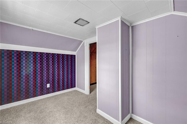 bonus room with carpet flooring and vaulted ceiling