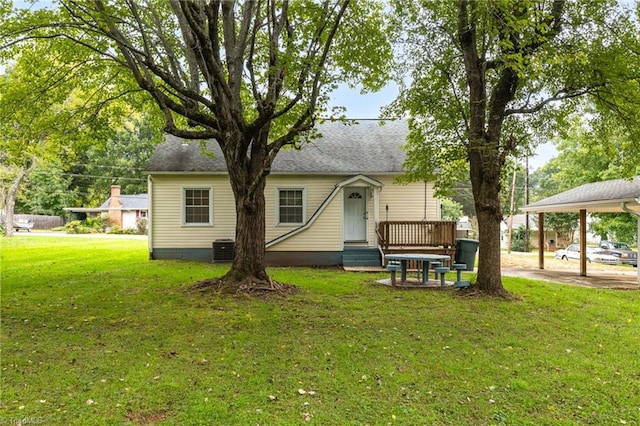 back of house with cooling unit and a yard