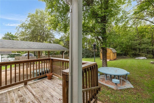 wooden deck featuring a shed and a yard