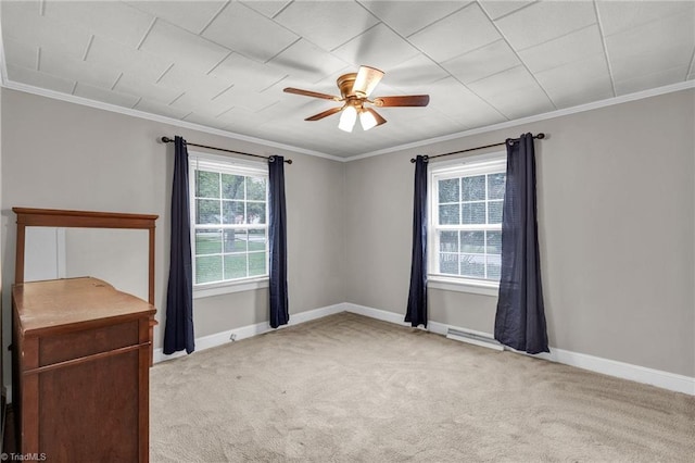 carpeted empty room featuring ceiling fan and crown molding