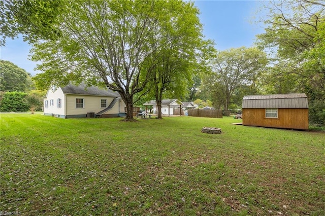 view of yard with a storage unit and an outdoor fire pit