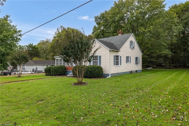 view of property exterior with a yard