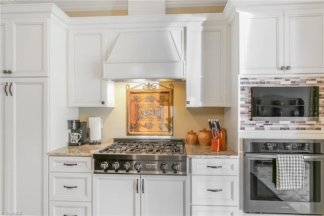 kitchen featuring stainless steel appliances, custom exhaust hood, and white cabinets