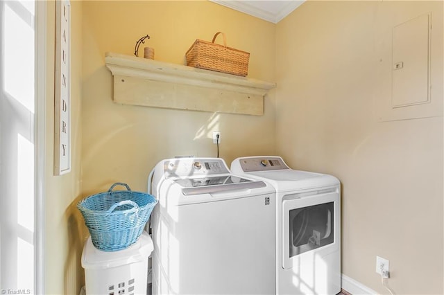 washroom with laundry area, crown molding, electric panel, and washing machine and dryer