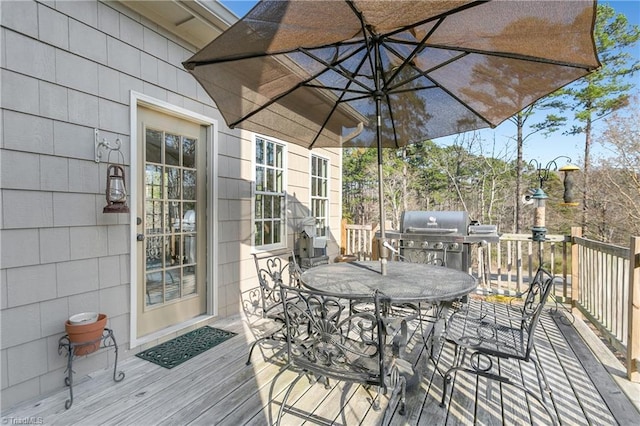 deck featuring area for grilling and outdoor dining area