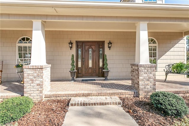 entrance to property featuring covered porch