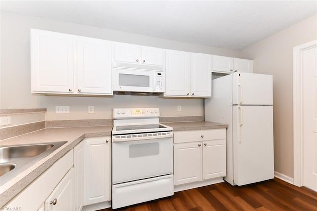 320 Apple Ridge Rd, Greensboro, NC 27406 - kitchen with white appliances, dark wood finished floors, white cabinetry, light countertops, and a sink