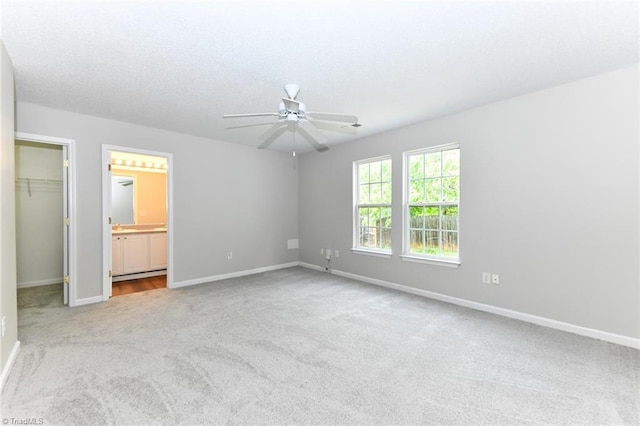 320 Apple Ridge Rd, Greensboro, NC 27406 - unfurnished bedroom featuring carpet floors, a spacious closet, baseboards, a closet, and ensuite bathroom