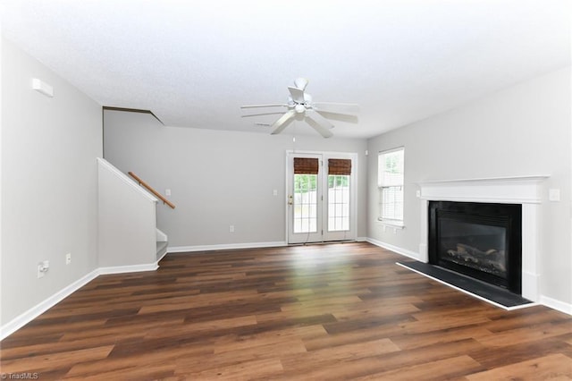 320 Apple Ridge Rd, Greensboro, NC 27406 - unfurnished living room featuring ceiling fan, stairway, a glass covered fireplace, wood finished floors, and baseboards