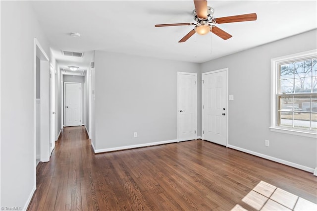 spare room with ceiling fan and dark hardwood / wood-style flooring