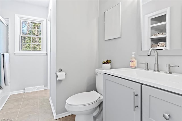 bathroom with tile patterned flooring, vanity, walk in shower, and toilet