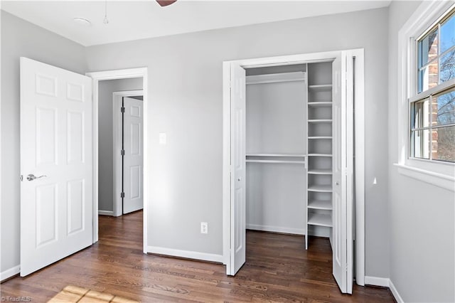 unfurnished bedroom featuring dark wood-type flooring and a closet