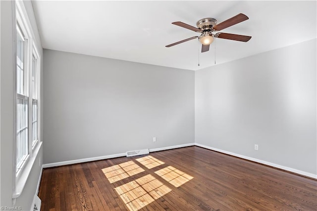 empty room with ceiling fan and dark hardwood / wood-style floors