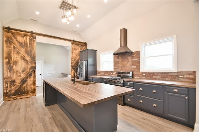 2244 US Highway 64 E, Mocksville, NC 27028 - kitchen featuring butcher block counters, stainless steel range with gas cooktop, lofted ceiling, island range hood, and a barn door