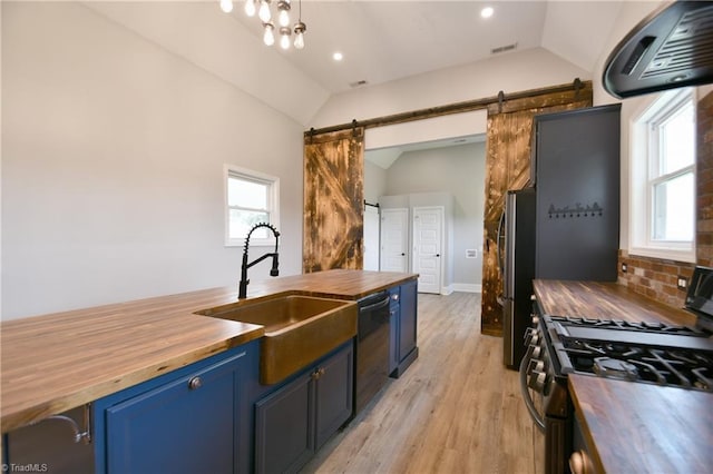 2244 US Highway 64 E, Mocksville, NC 27028 - kitchen with wooden counters, stainless steel appliances, blue cabinetry, vaulted ceiling, and a barn door