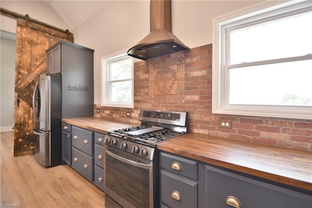 2244 US Highway 64 E, Mocksville, NC 27028 - kitchen featuring wood counters, appliances with stainless steel finishes, island exhaust hood, light wood-style floors, and tasteful backsplash