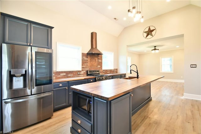 2244 US Highway 64 E, Mocksville, NC 27028 - kitchen with stainless steel appliances, wooden counters, island range hood, vaulted ceiling, and backsplash
