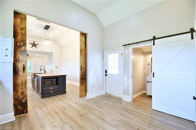 2244 US Highway 64 E, Mocksville, NC 27028 - entryway featuring lofted ceiling, a barn door, light wood-style floors, and healthy amount of natural light