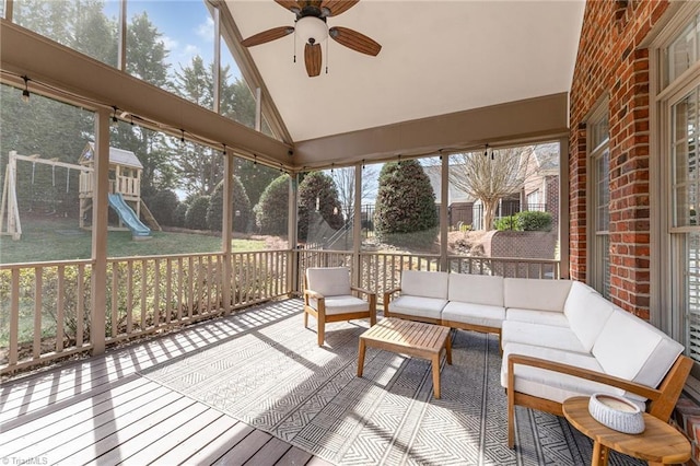 sunroom / solarium featuring vaulted ceiling, a healthy amount of sunlight, and ceiling fan